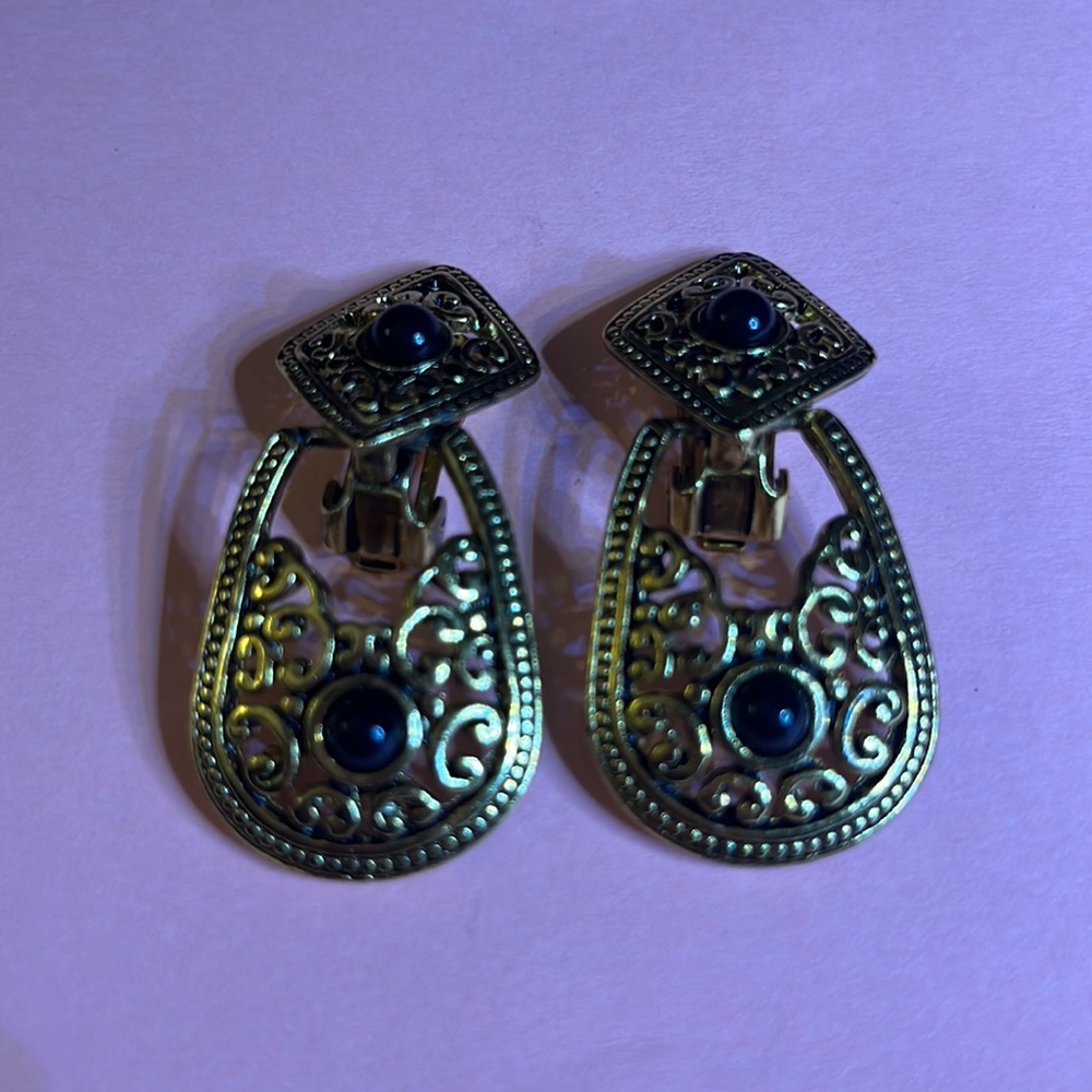 Gold tone clip on earrings with black stones